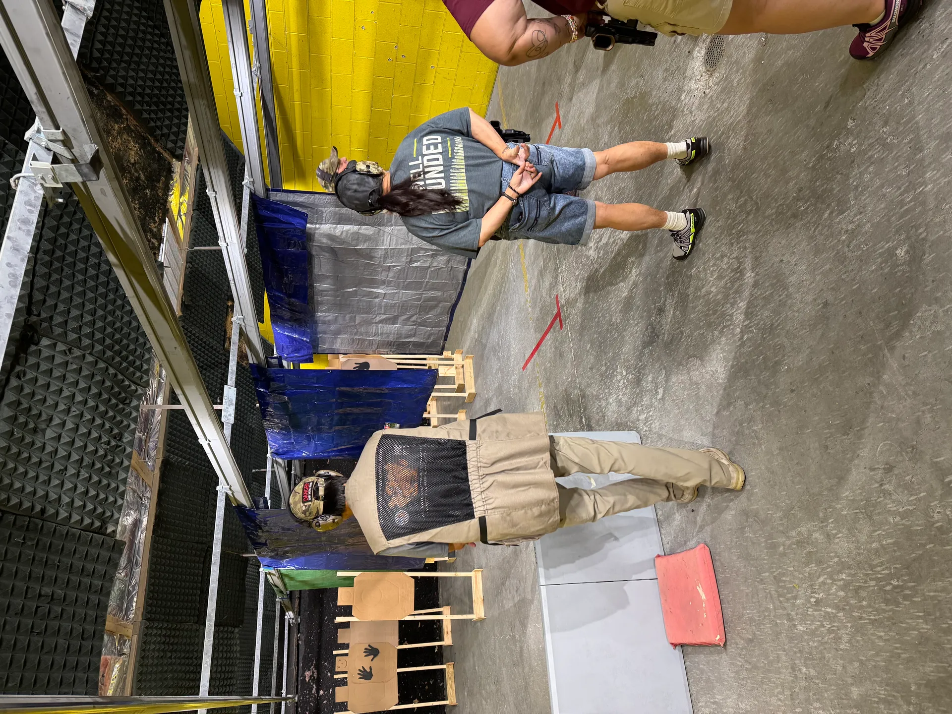 Two people coaching in the indoor range bay